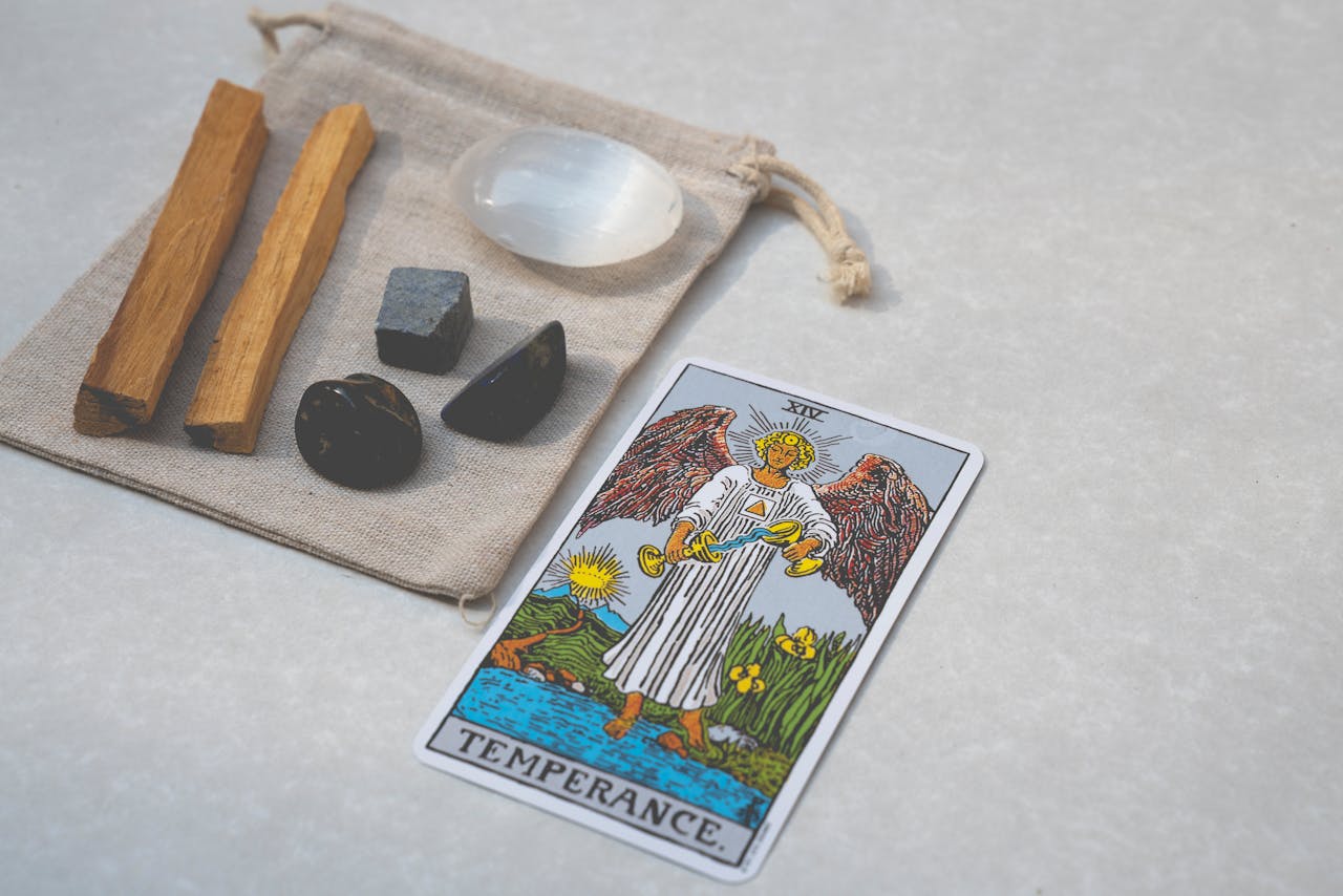 Temperance tarot card with healing crystals and Palo Santo on white background. Perfect for spirituality themes.